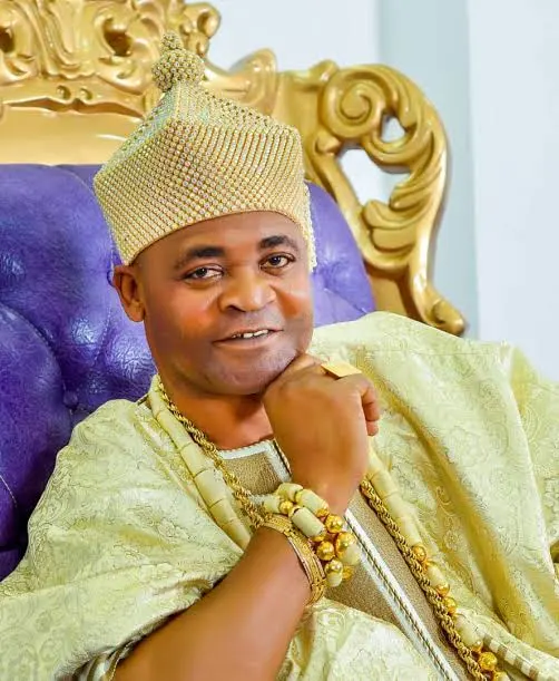 Smiling portrait in white attire and red cap from public celebration